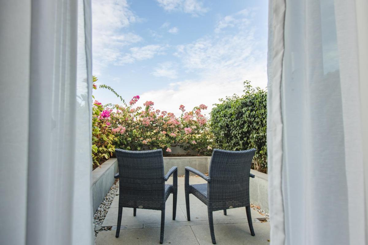 two chairs and a table on a balcony at The Residency Towers, Rameswaram in Rāmeswaram