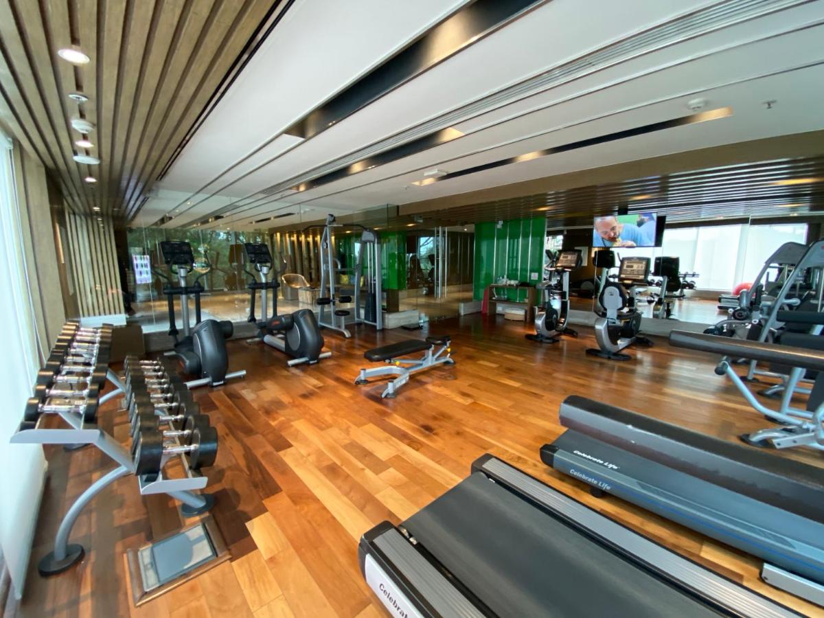 a gym with several treadmills and exercise bikes at Welcomhotel by ITC Hotels, Richmond Road, Bengaluru in Bengaluru