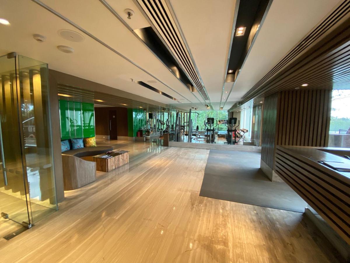 a large lobby with wooden floors and glass walls at Welcomhotel by ITC Hotels, Richmond Road, Bengaluru in Bengaluru