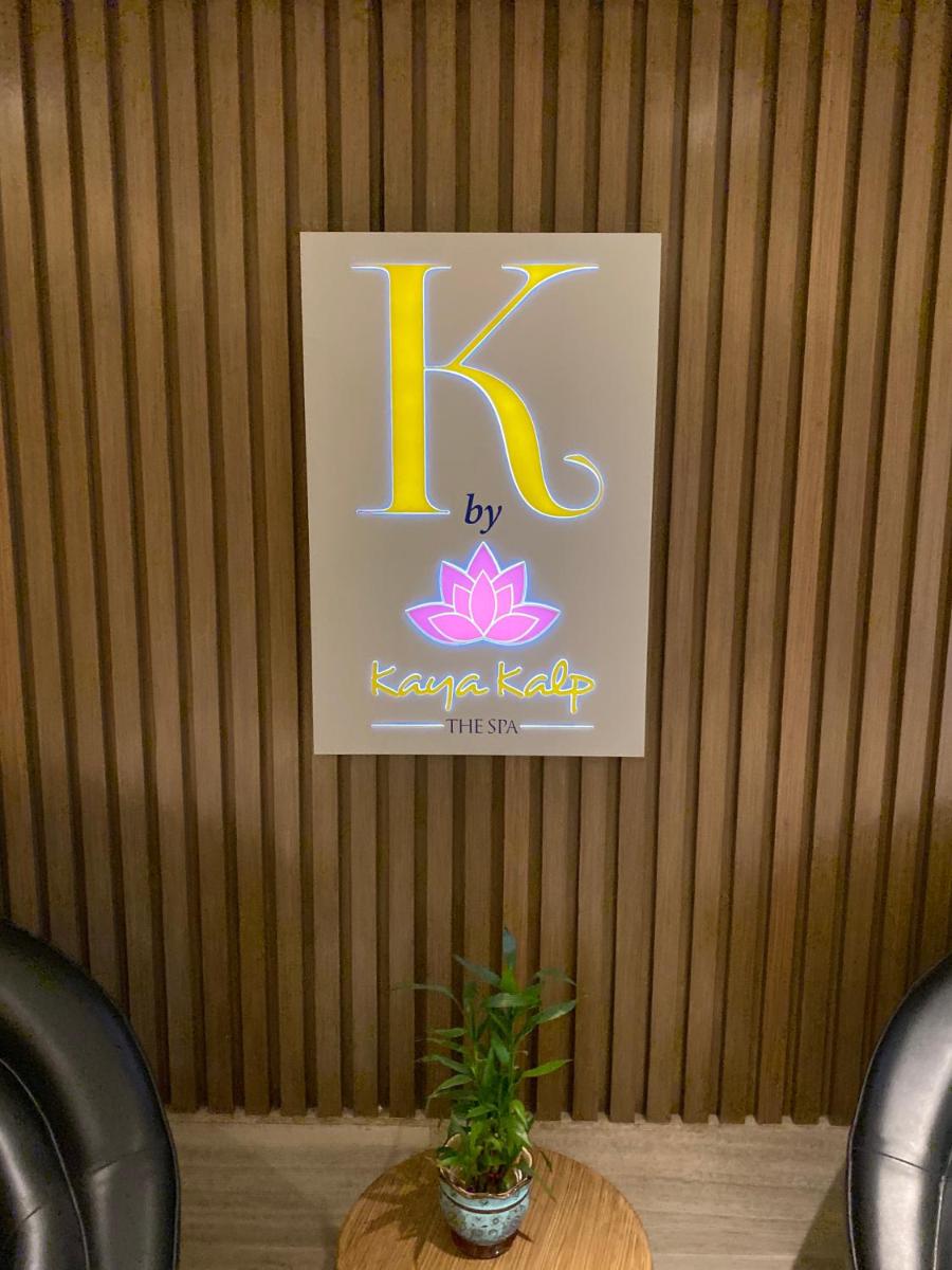 a sign on a wooden wall with a karma relay sign at Welcomhotel by ITC Hotels, Richmond Road, Bengaluru in Bengaluru