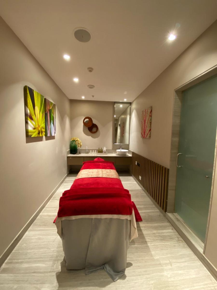 a bedroom with a bed with a red blanket at Welcomhotel by ITC Hotels, Richmond Road, Bengaluru in Bengaluru