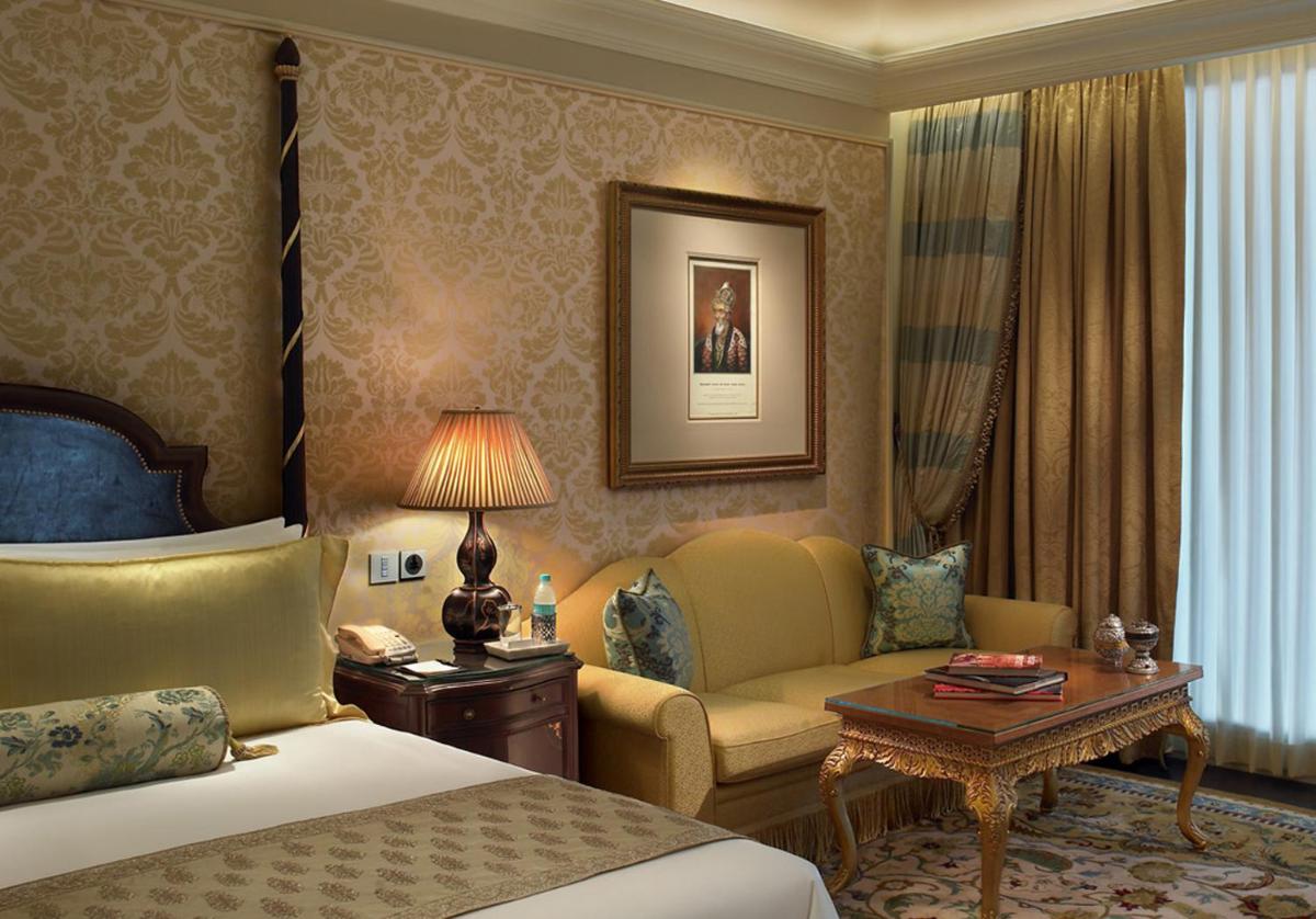 a hotel room with a bed and a couch at The Leela Palace New Delhi in New Delhi a hotel room with a bed and a couch at The Leela Palace New Delhi in New Delhi