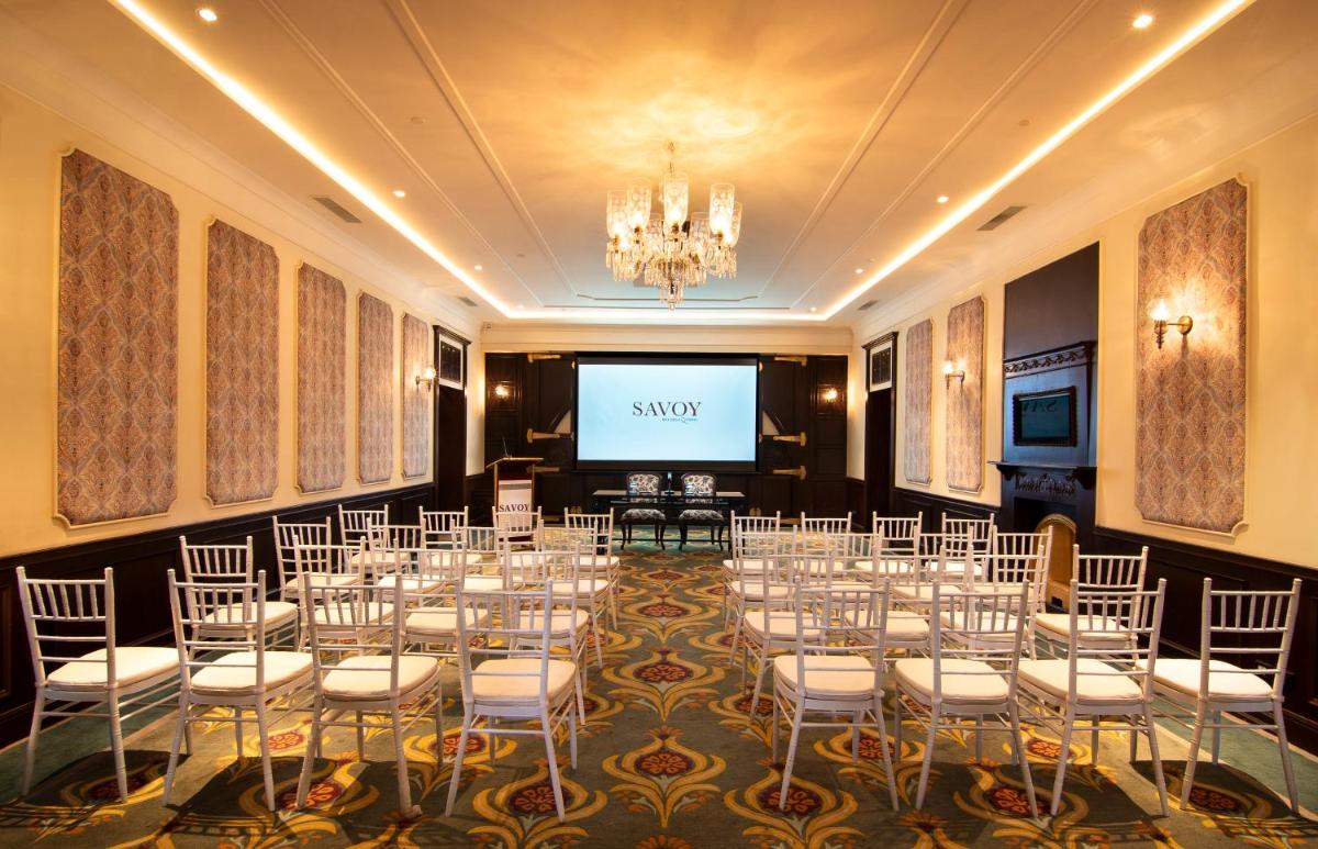 a room with a set up for a wedding with a screen at Savoy - IHCL SeleQtions in Ooty