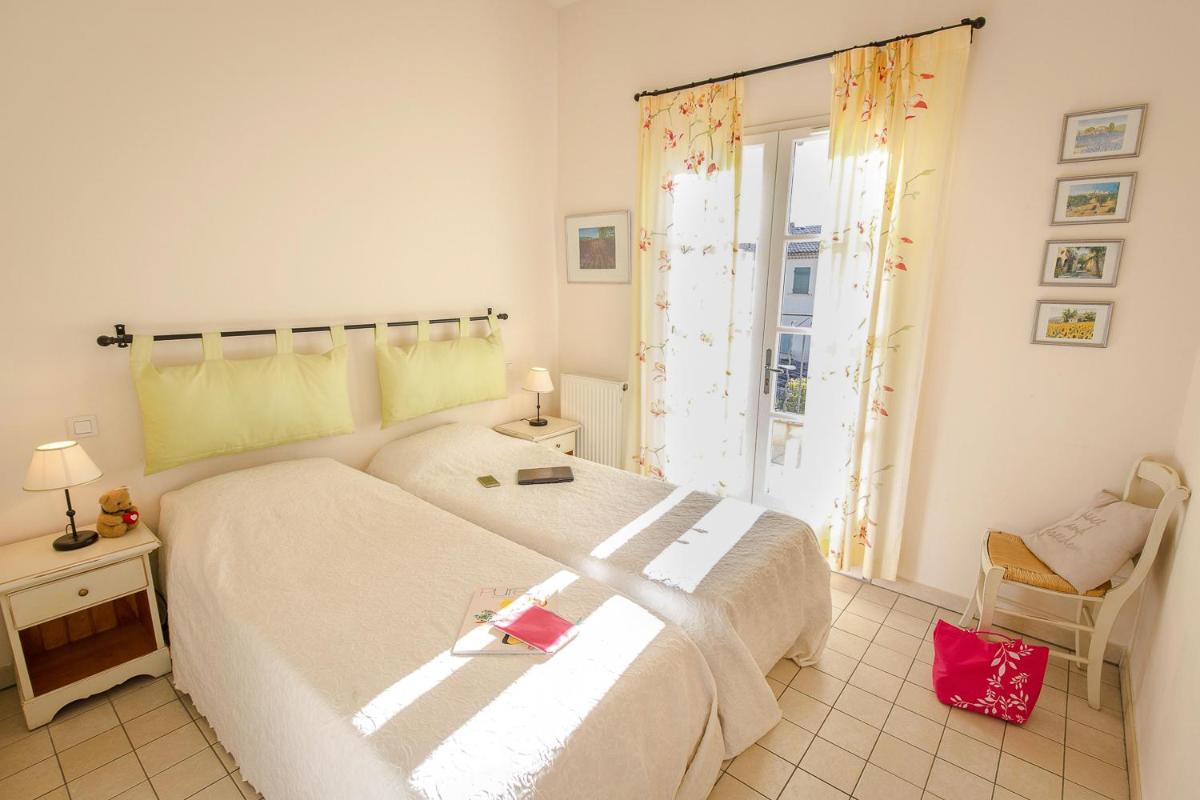 Un ou plusieurs lits dans un hébergement de l'établissement Les Appartements et Maisons du Domaine de Saint Endréol Golf & Spa Resort