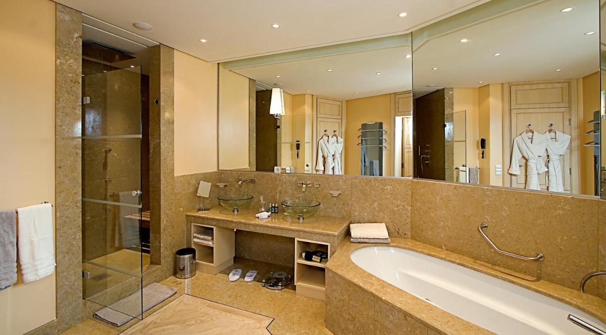 une salle de bain avec une baignoire et un grand miroir dans l'établissement Bastide Saint Antoine - Relais & Châteaux, à Grasse