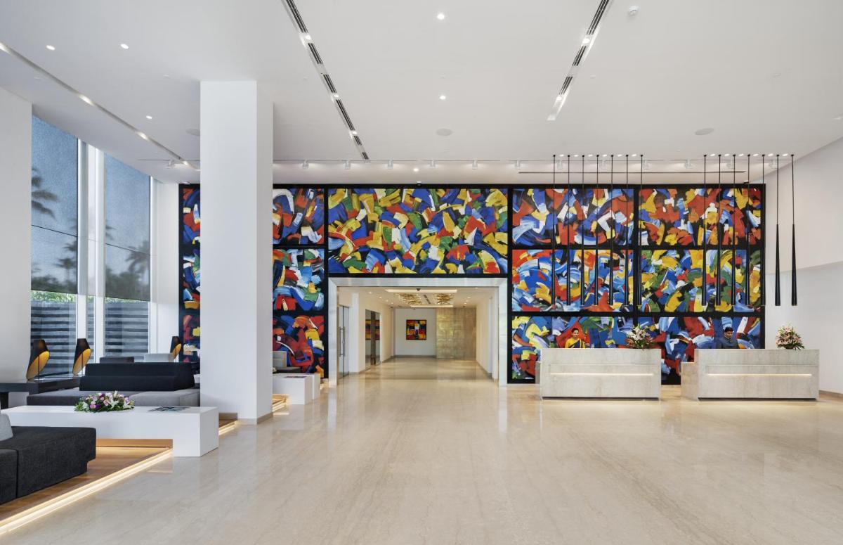 a lobby with a large colorful mural on the wall at O by Tamara, Trivandrum in Trivandrum