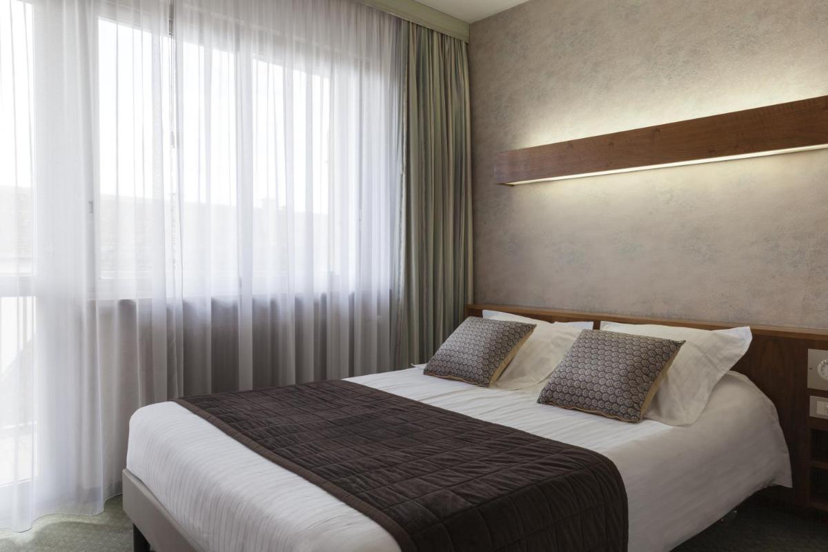 Un ou plusieurs lits dans un hébergement de l'établissement Hotel Munsch Restaurant & Wellness, Colmar Nord - Haut-Koenigsbourg