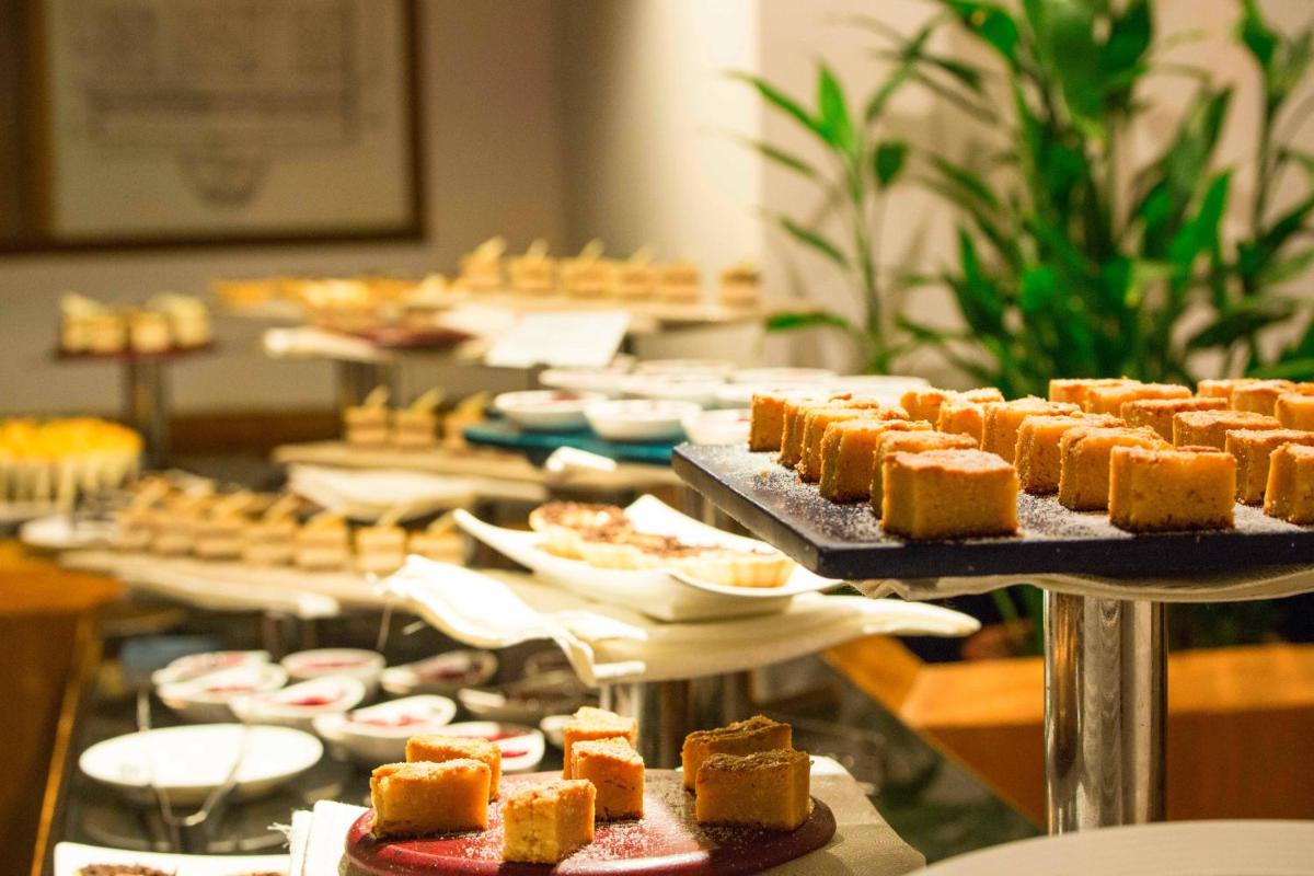 a buffet with many plates of food on display at Casino Hotel - CGH Earth, Cochin in Cochin