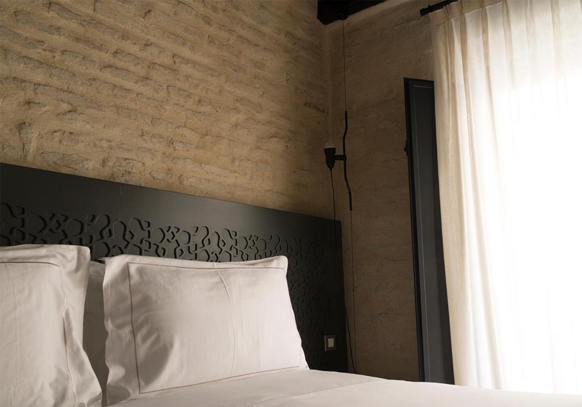 Cama o camas de una habitación en EME Catedral Mercer Hotel
