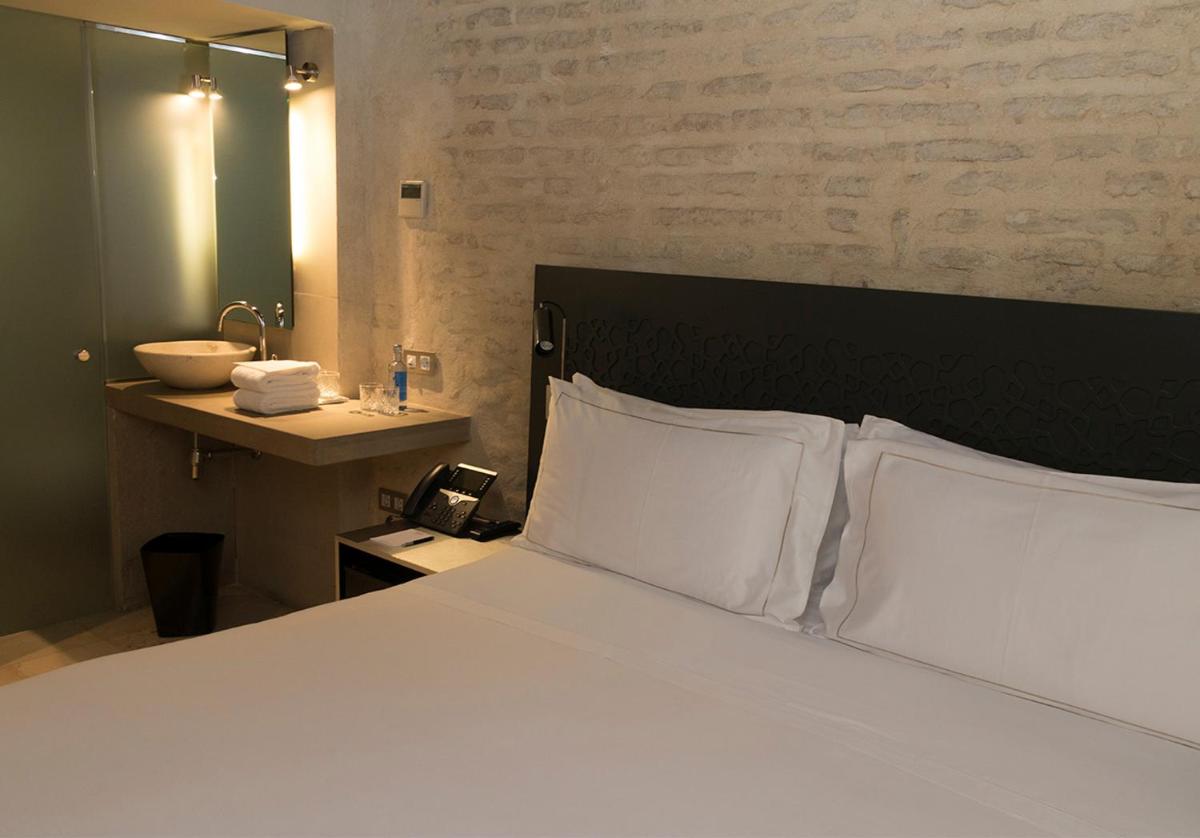 Cama o camas de una habitación en EME Catedral Mercer Hotel