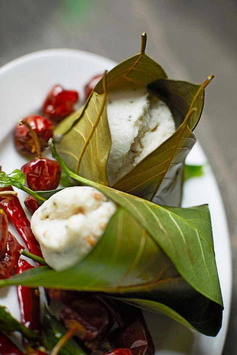 a white plate of food with a salad with leaves at Taj Tirupati in Tirupati