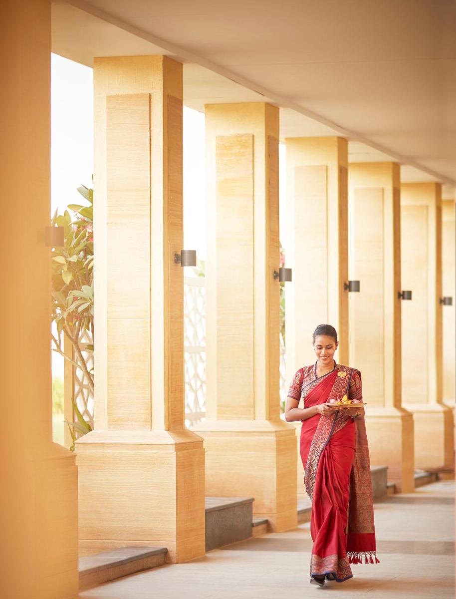 a woman standing in front of a building at Taj Tirupati in Tirupati