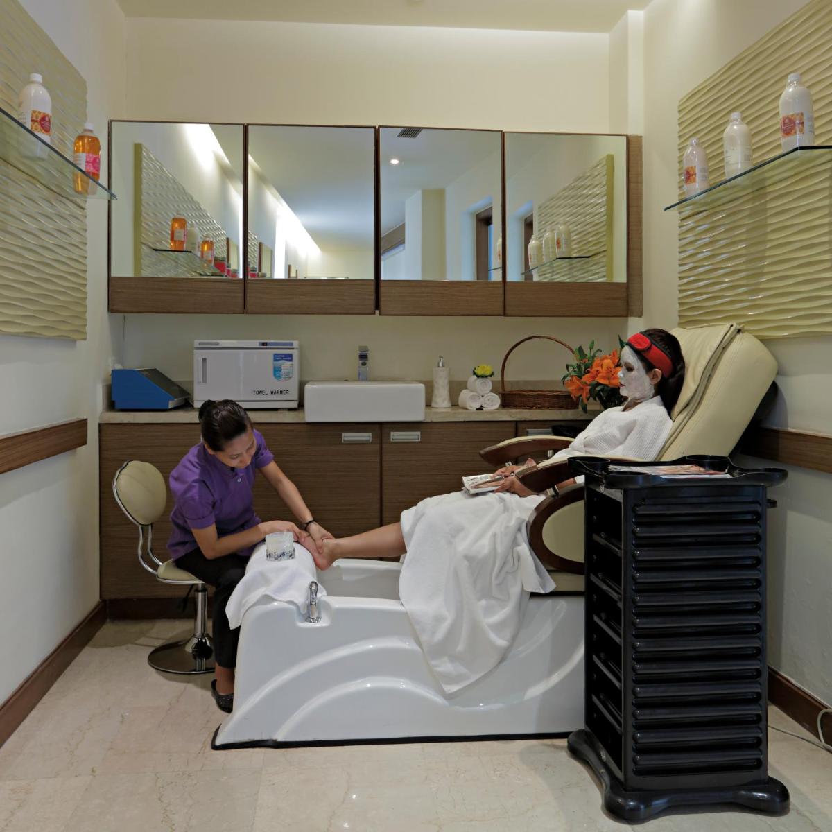two women in a hospital room with a patient laying in a bed at Radisson Blu Hotel, Greater Noida in Greater Noida