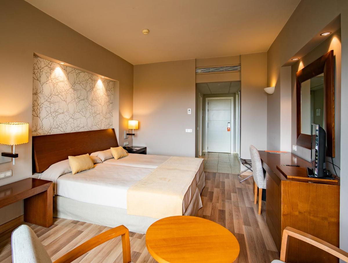 Cama o camas de una habitación en Hotel Valle del Este