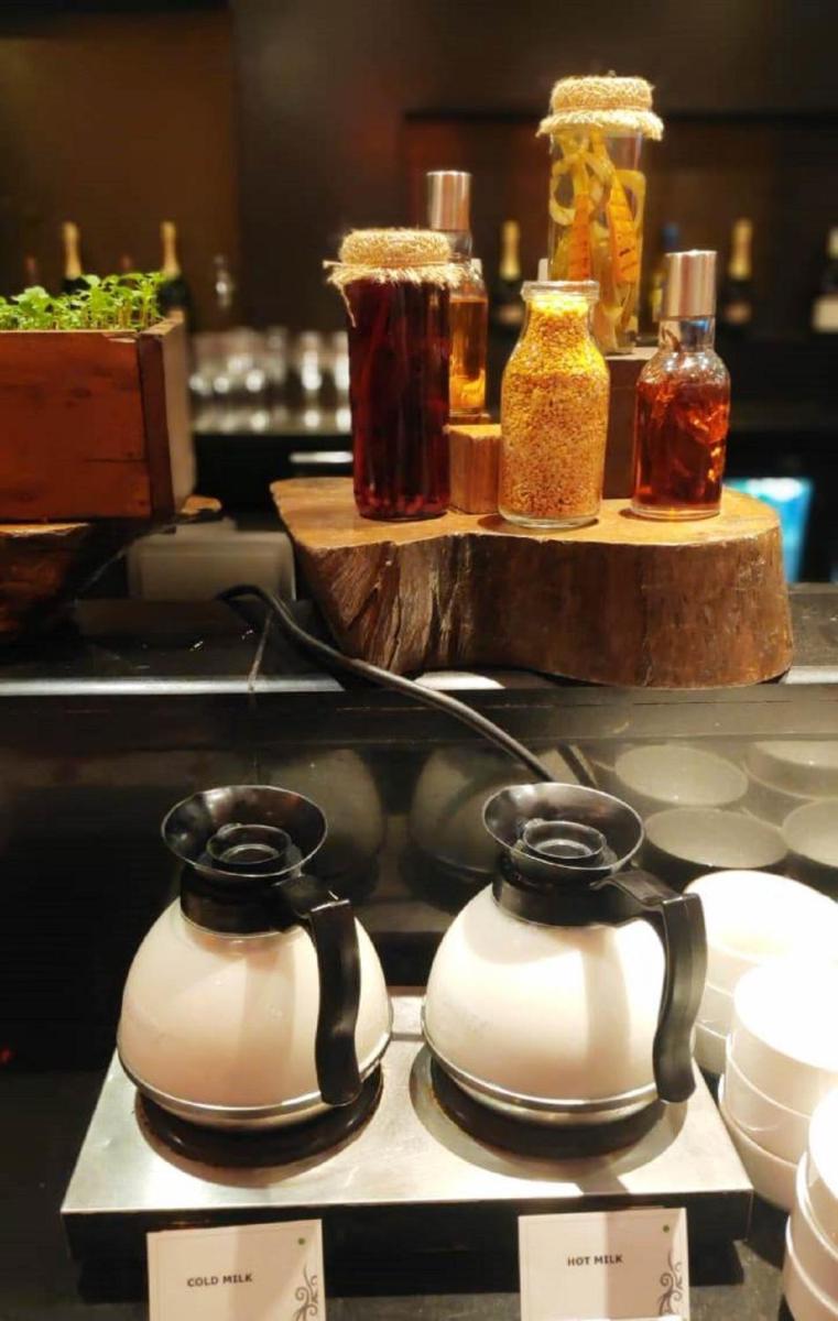 a couple of tea pots on a counter with spices at Hard Rock Hotel Goa Calangute in Calangute