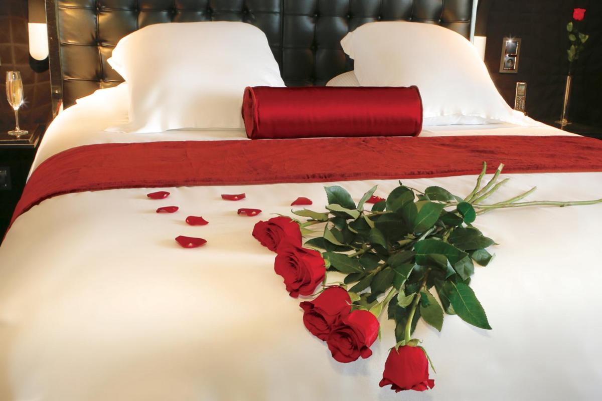 Un ou plusieurs lits dans un hébergement de l'établissement Oz'Inn Hôtel & Spa