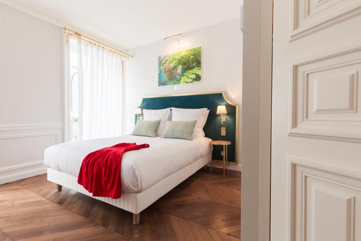 Un ou plusieurs lits dans un hébergement de l'établissement Hôtel Alfred Sommier