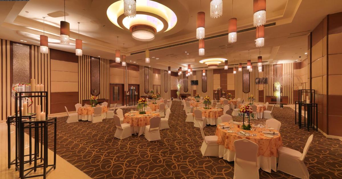 a banquet hall with white tables and white chairs at Radisson Blu Hotel, Greater Noida in Greater Noida