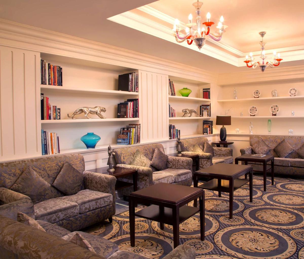a living room with couches and bookshelves at Radisson Blu Kochi in Cochin