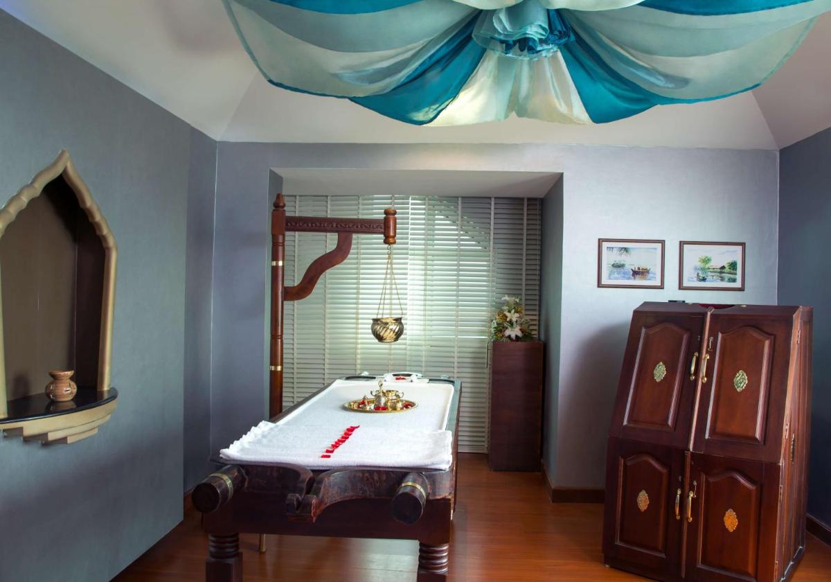 a bathroom with a sink and a shower with a ceiling at Radisson Blu Kochi in Cochin