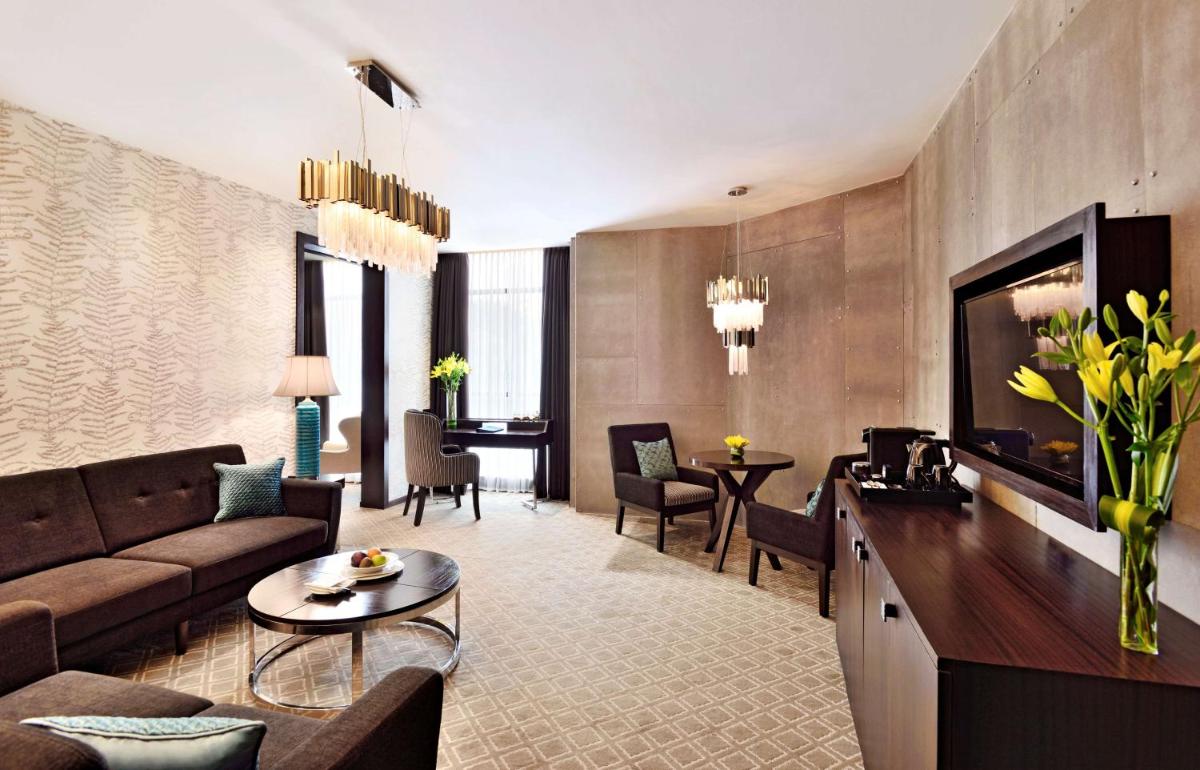 a living room with a couch and a table at Radisson Blu Atria Bengaluru in Bengaluru a living room with a couch and a table at Radisson Blu Atria Bengaluru in Bengaluru