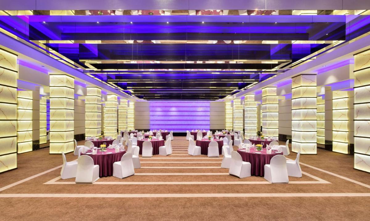 a banquet hall with tables and chairs and purple lighting at Radisson Blu Atria Bengaluru in Bengaluru +73 photos a banquet hall with tables and chairs and purple lighting at Radisson Blu Atria Bengaluru in Bengaluru +73 photos