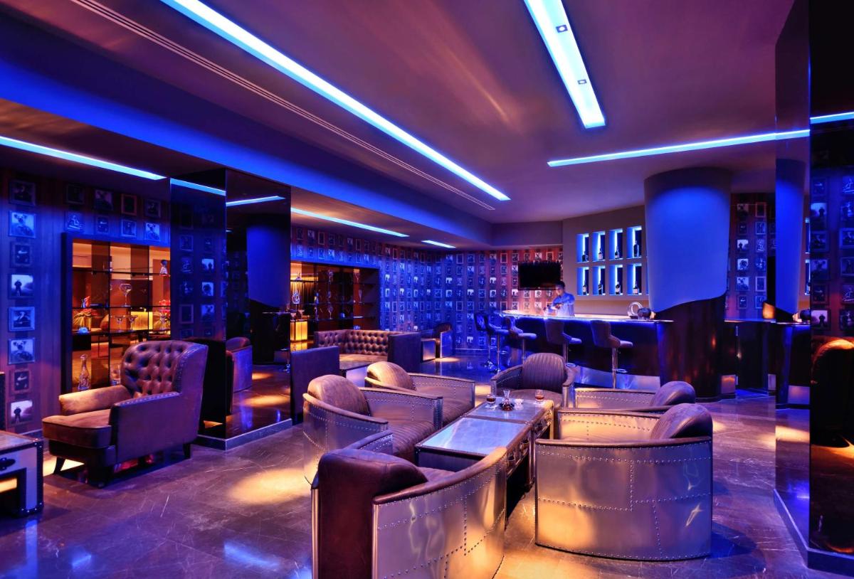 a bar with couches and tables in a room at Radisson Blu Atria Bengaluru in Bengaluru a bar with couches and tables in a room at Radisson Blu Atria Bengaluru in Bengaluru