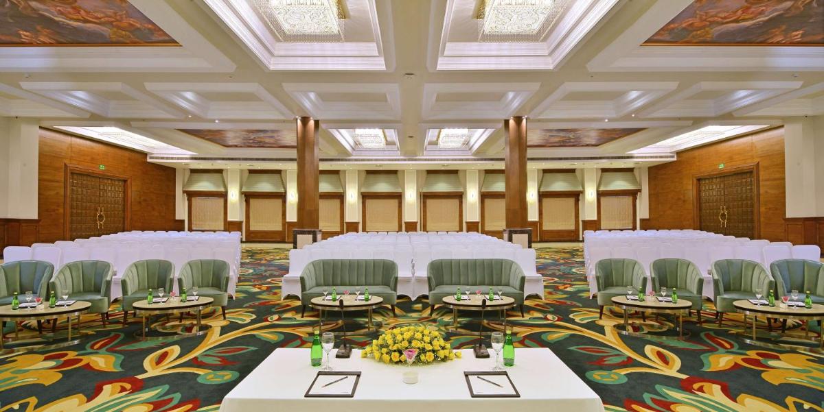 a banquet hall with white tables and chairs at Radisson Chandigarh Zirakpur in Chandīgarh