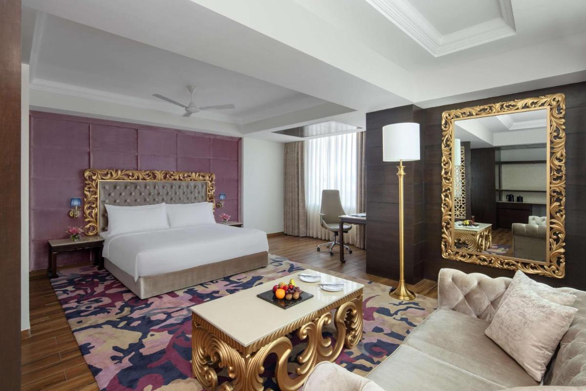 a hotel room with a bed and a mirror at Radisson Chandigarh Zirakpur in Chandīgarh