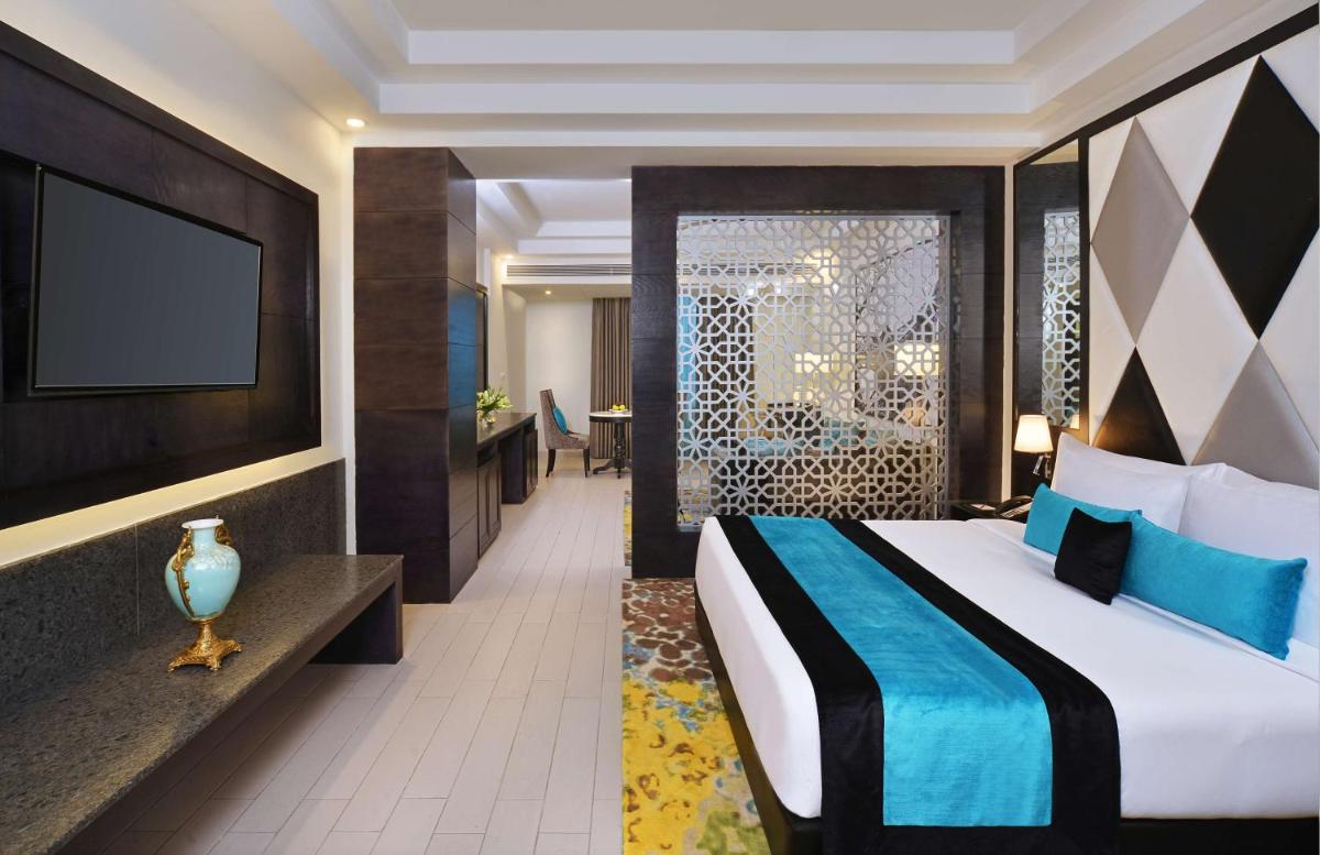 a hotel room with a bed and a tv at Radisson Chandigarh Zirakpur in Chandīgarh