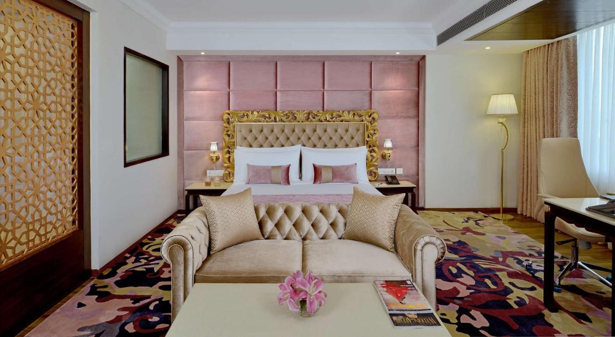a hotel room with a bed and a couch at Radisson Chandigarh Zirakpur in Chandīgarh