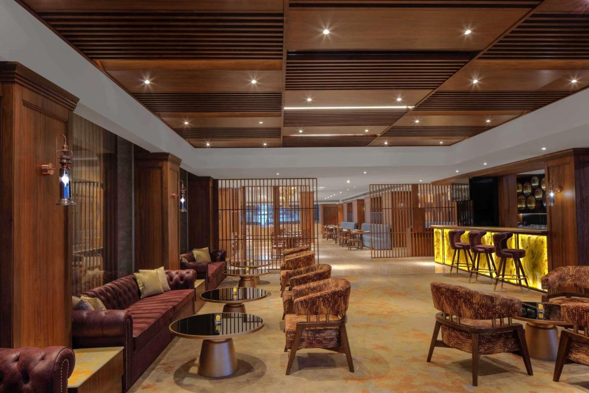 a lobby with couches and chairs and a bar at Radisson Chandigarh Zirakpur in Chandīgarh