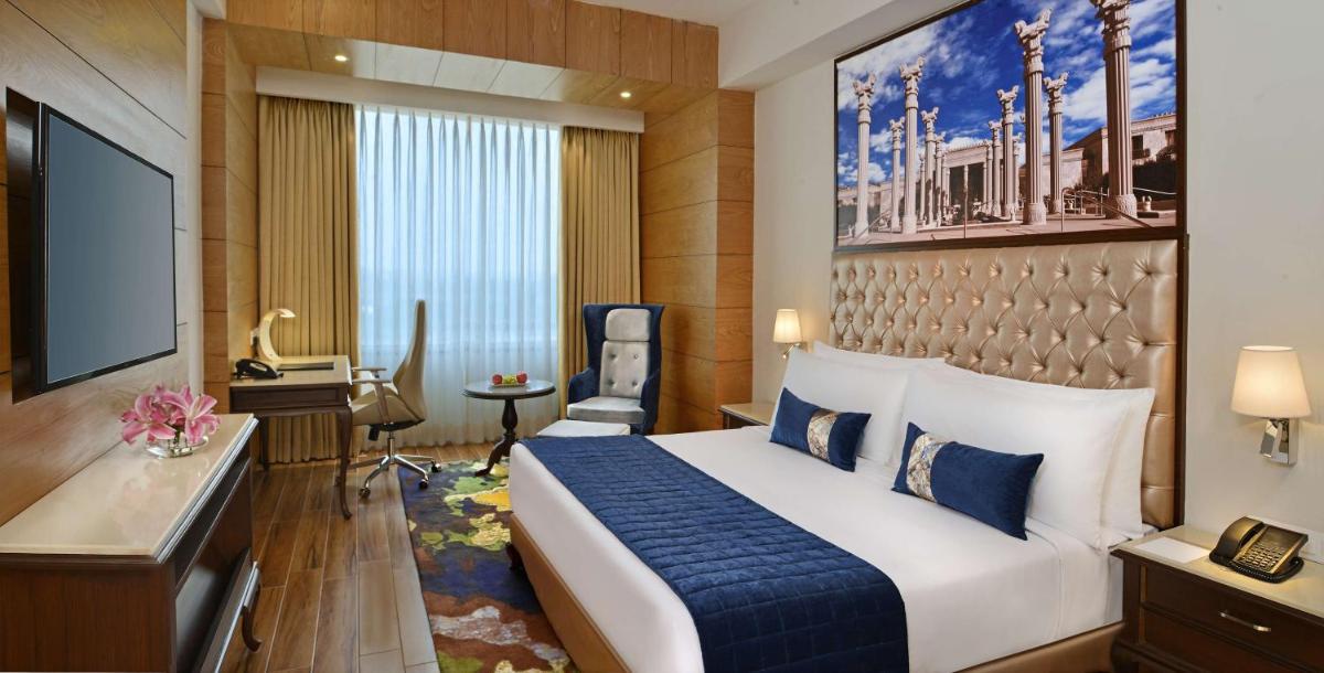 a hotel room with a bed and a television at Radisson Chandigarh Zirakpur in Chandīgarh