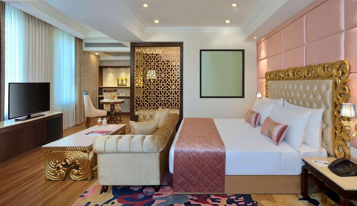 a hotel room with a bed and a television at Radisson Chandigarh Zirakpur in Chandīgarh