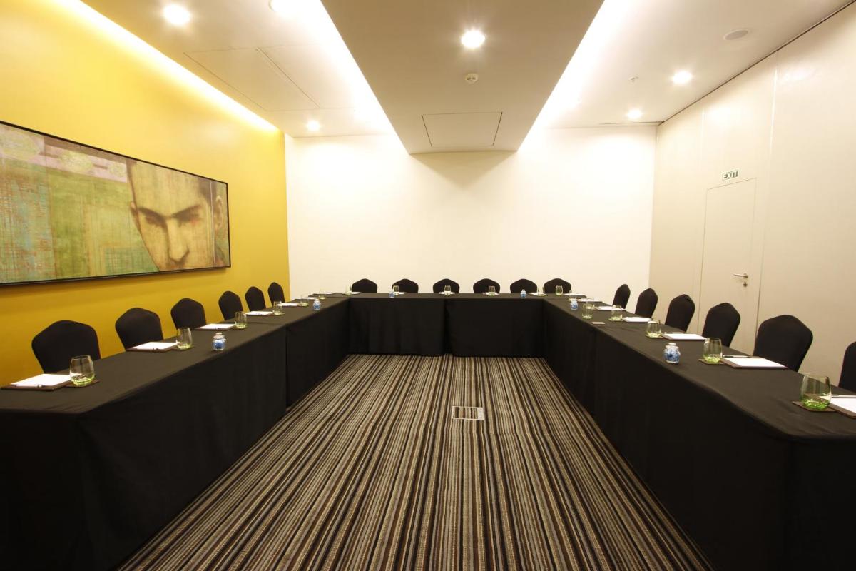 a conference room with desks and chairs in it at Crowne Plaza Pune City Centre by IHG in Pune