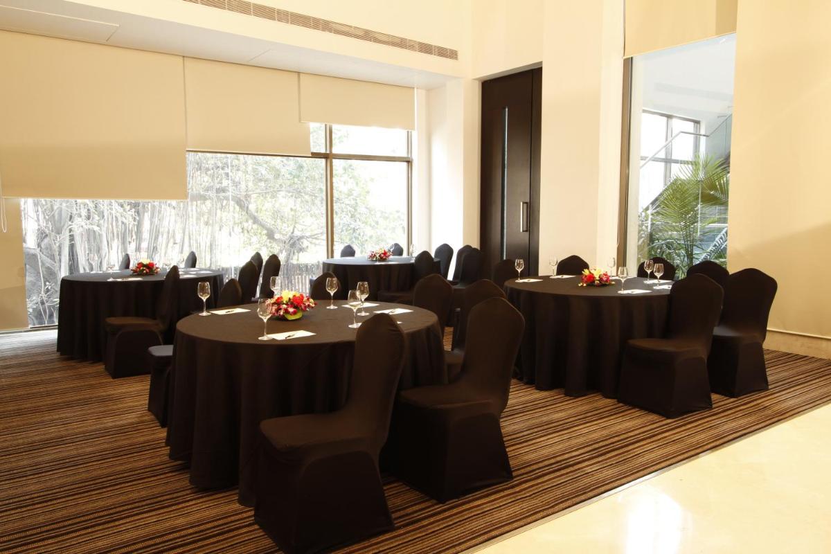 a conference room with round tables and chairs at Crowne Plaza Pune City Centre by IHG in Pune