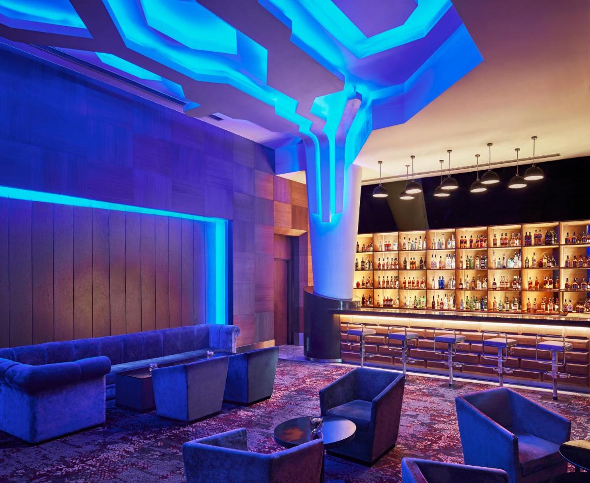 a lobby with blue lighting and couches and a bar at Taj Agra in Agra