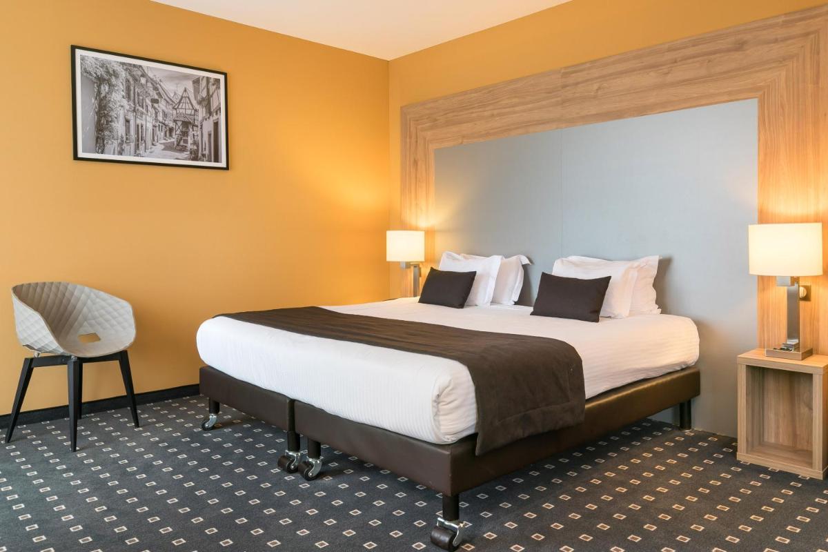 Un ou plusieurs lits dans un hébergement de l'établissement 7Hotel&Spa