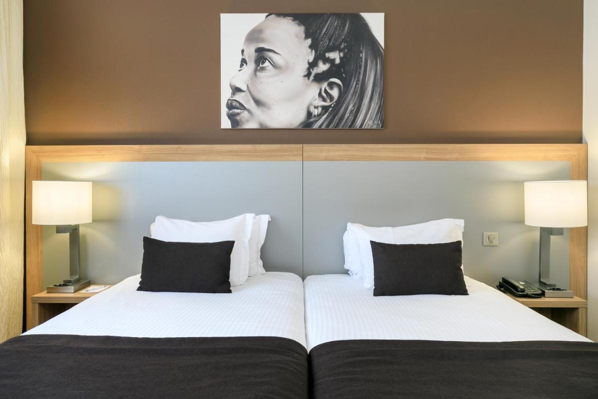 Un ou plusieurs lits dans un hébergement de l'établissement 7Hotel&Spa