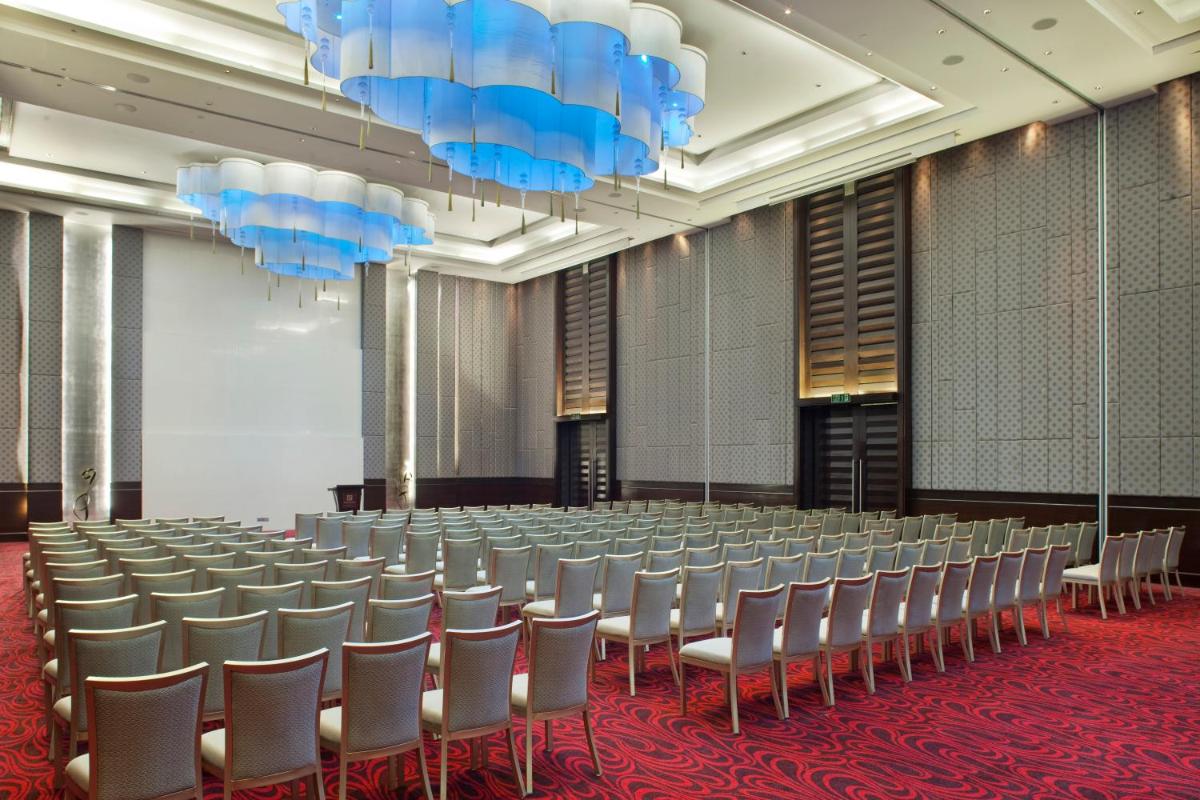 a conference room with rows of chairs in a row at Holiday Inn Mumbai International Airport by IHG in Mumbai