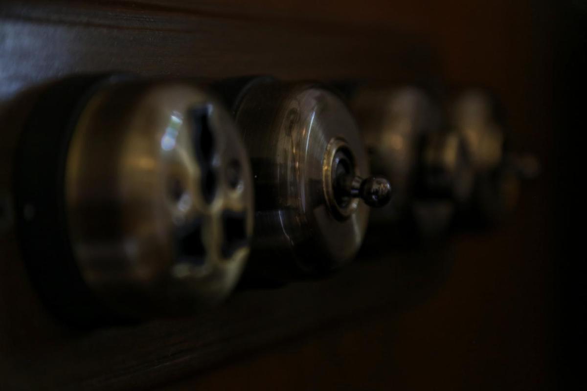 a row of wine bottles sitting on a shelf at The Postcard Cuelim, Goa in Cansaulim