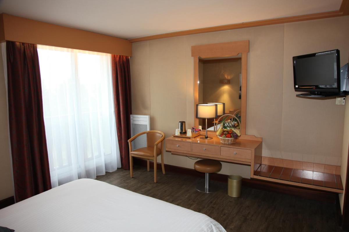 Un ou plusieurs lits dans un hébergement de l'établissement Amirauté Hôtel Golf Deauville