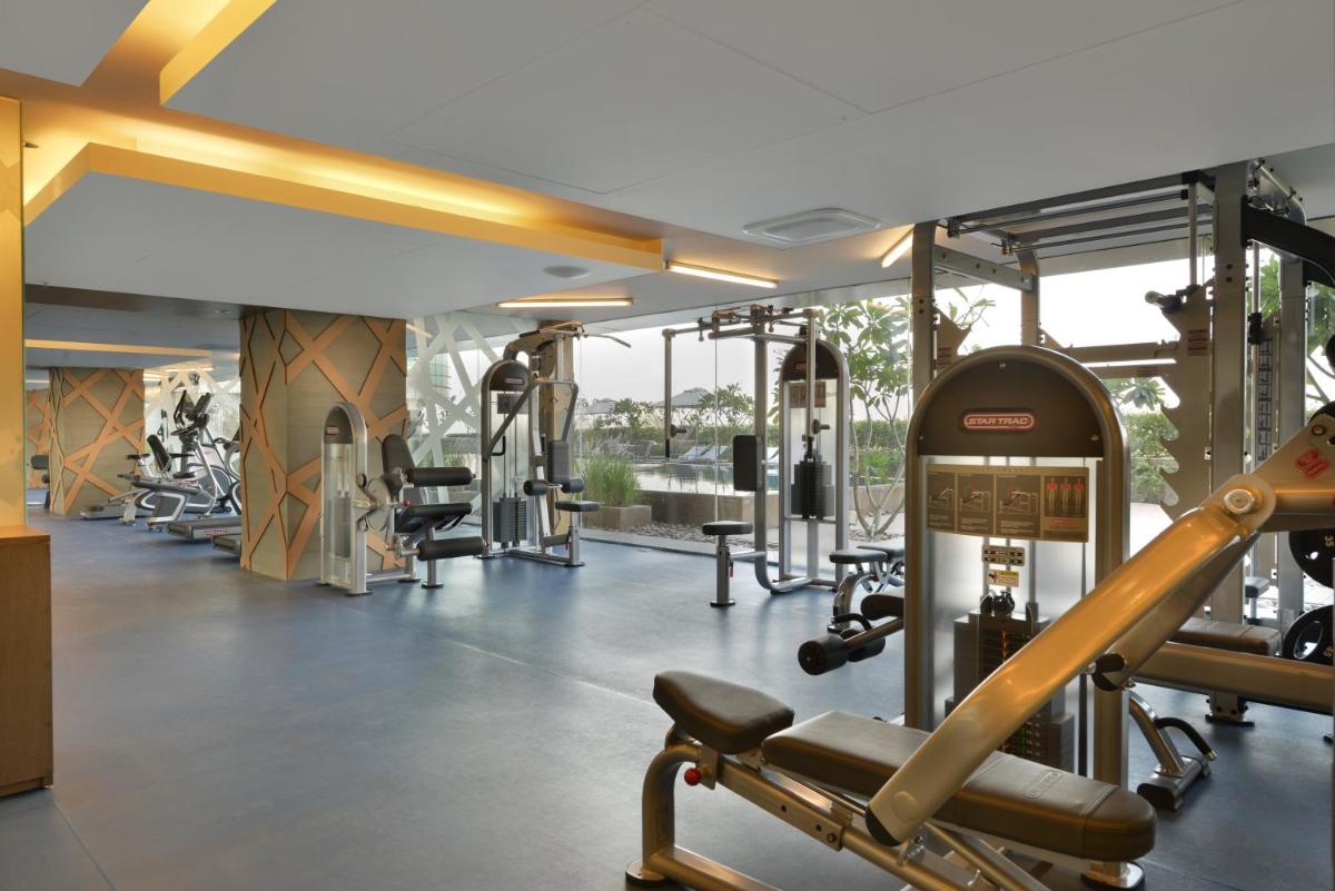 a gym with a lot of treadmills and machines at Crowne Plaza Ahmedabad City Centre by IHG in Ahmedabad