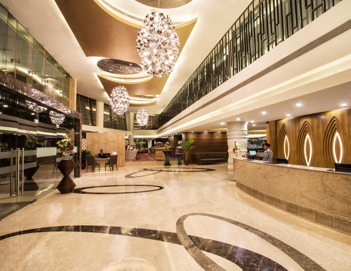a lobby of a hotel with a chandelier at Crowne Plaza Ahmedabad City Centre by IHG in Ahmedabad