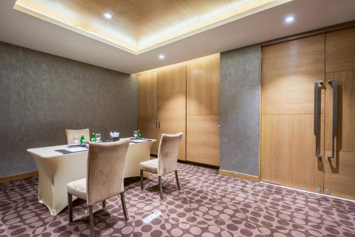 a conference room with a table and chairs and cabinets at Crowne Plaza Ahmedabad City Centre by IHG in Ahmedabad