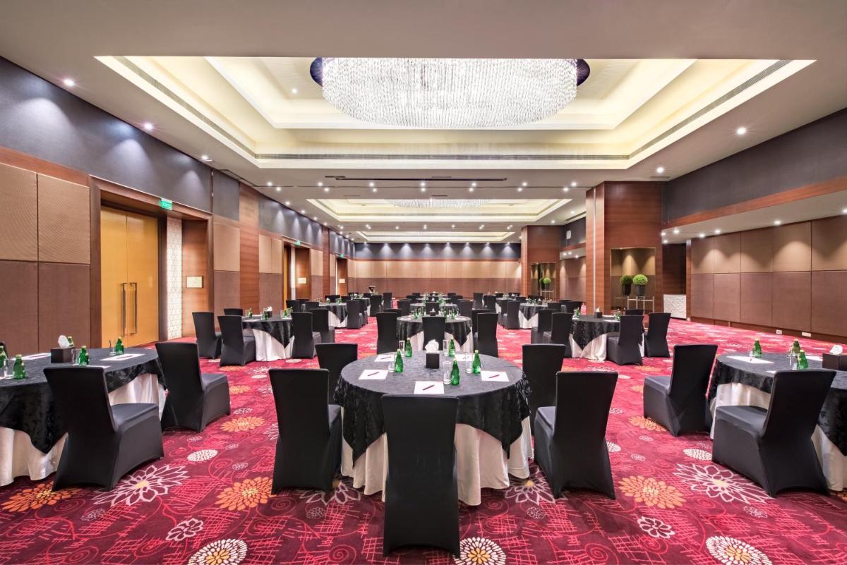 a large banquet hall with tables and chairs at Crowne Plaza Ahmedabad City Centre by IHG in Ahmedabad