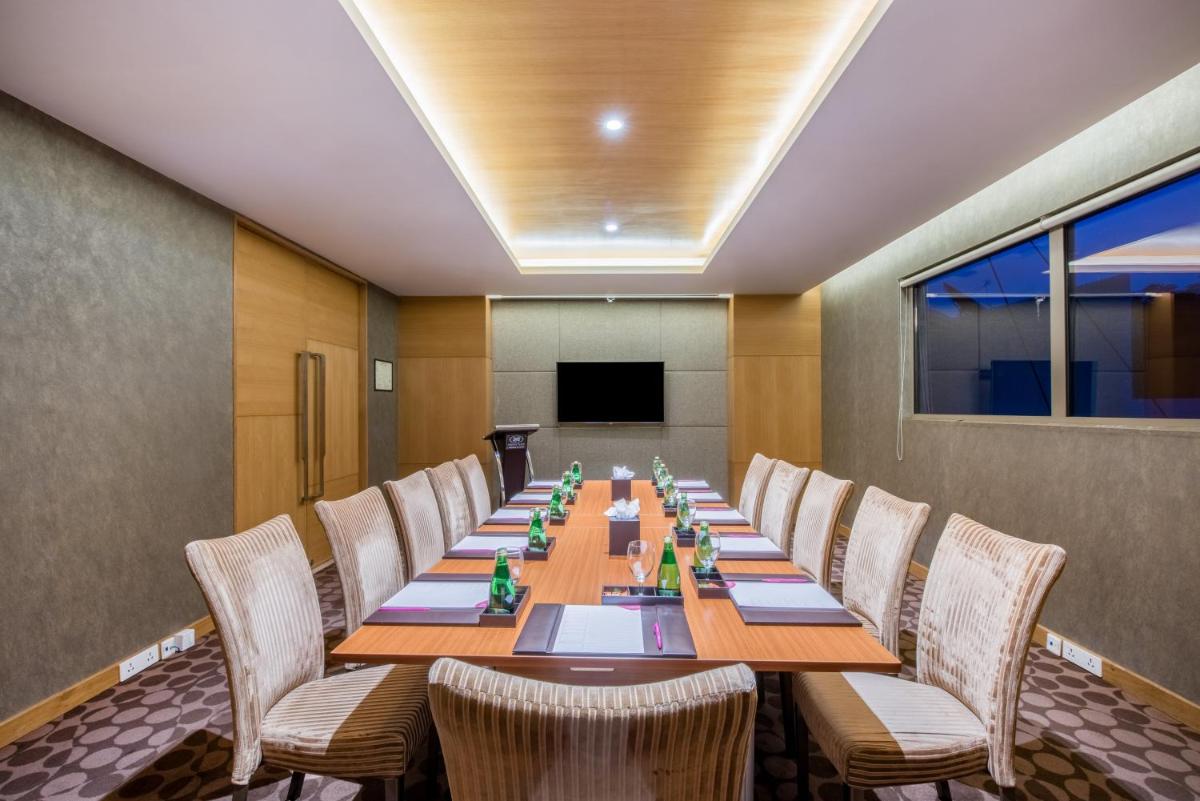 a conference room with a long table and chairs at Crowne Plaza Ahmedabad City Centre by IHG in Ahmedabad