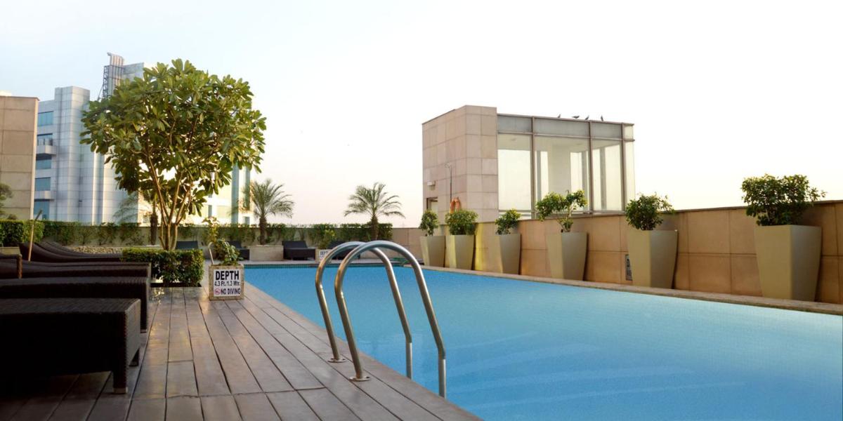 a swimming pool on top of a building at Crowne Plaza New Delhi Okhla by IHG in New Delhi