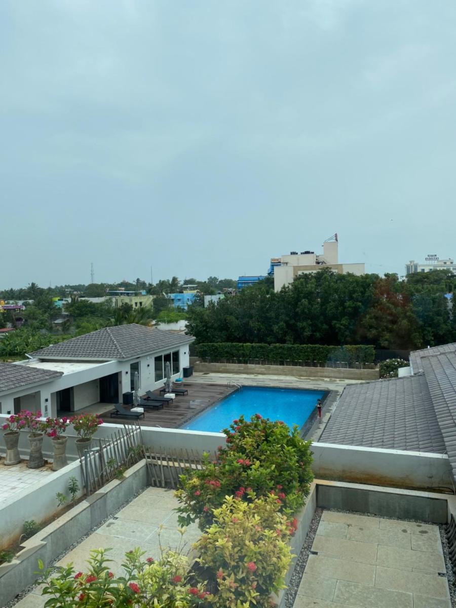a swimming pool on the roof of a house at The Residency Towers, Rameswaram in Rāmeswaram
