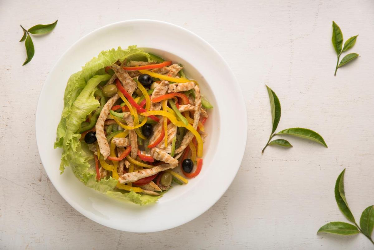 a white bowl of salad with chicken and vegetables at Savoy - IHCL SeleQtions in Ooty